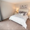 a bedroom with a bed and two nightstands