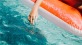 a person sitting on a floaty in a pool